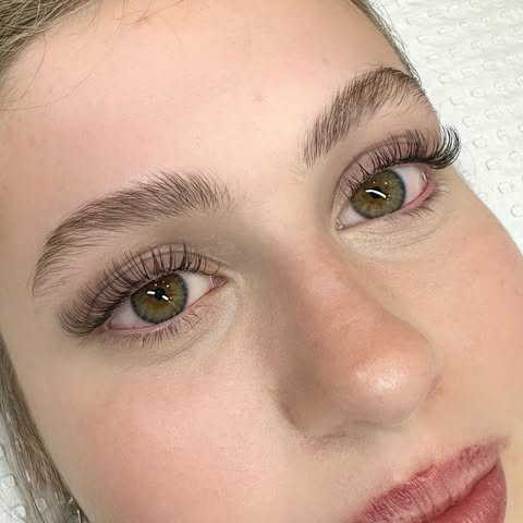 Client with shaped brows and lash extensions